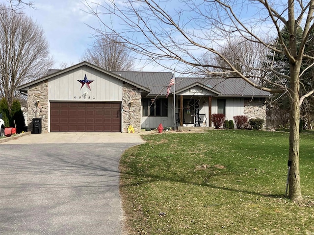 view of front of home with a front yard and a garage