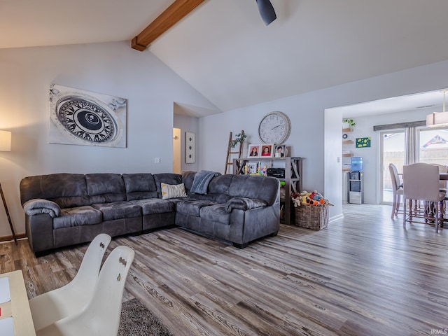 living room with hardwood / wood-style floors and vaulted ceiling with beams