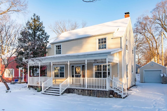 view of front of property featuring a porch, a garage, and an outbuilding