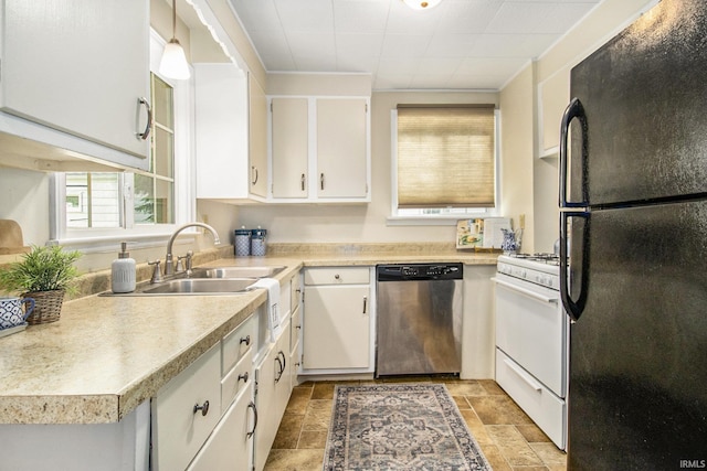 kitchen featuring stainless steel dishwasher, white range with gas cooktop, black refrigerator, white cabinets, and sink