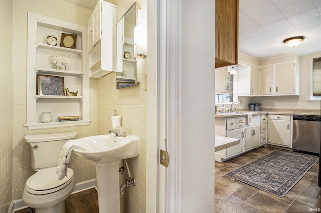 bathroom featuring sink, built in features, and toilet