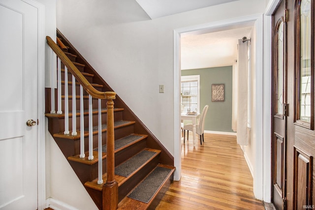 stairway with hardwood / wood-style floors