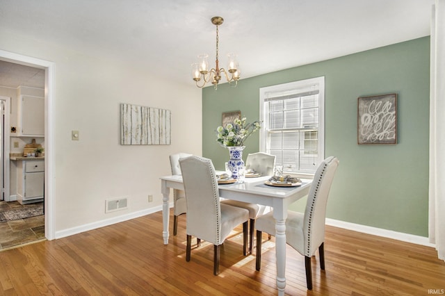 dining area featuring a chandelier and hardwood / wood-style flooring