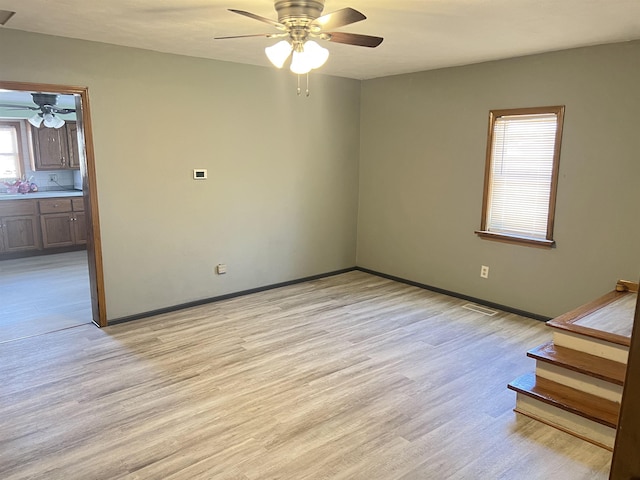 unfurnished room featuring ceiling fan and light hardwood / wood-style flooring