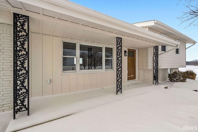 view of snow covered property entrance