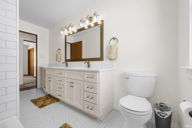 bathroom with toilet, tile patterned flooring, and vanity