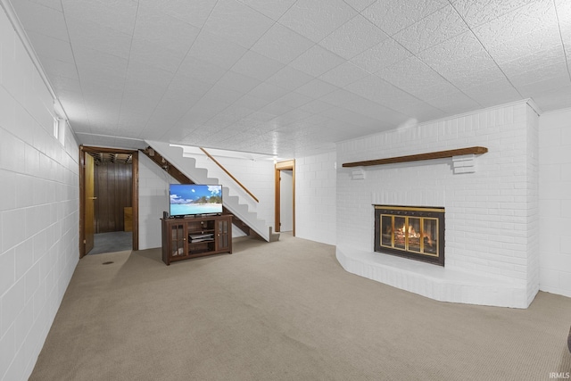 unfurnished living room with a brick fireplace and carpet flooring