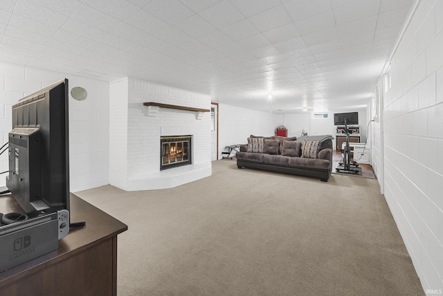 living room with a brick fireplace and carpet floors