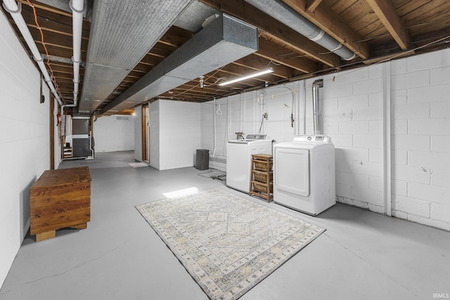 basement with washer and clothes dryer and heating unit