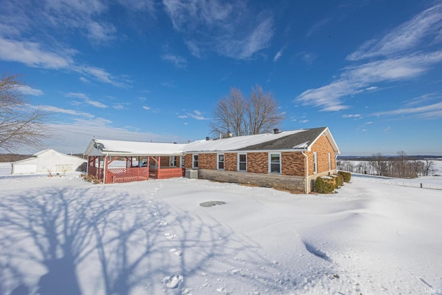 snow covered property with a porch