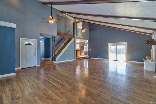 unfurnished living room with high vaulted ceiling, ceiling fan, beamed ceiling, and dark wood-type flooring