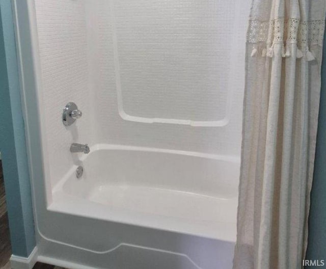 bathroom featuring shower / tub combo with curtain