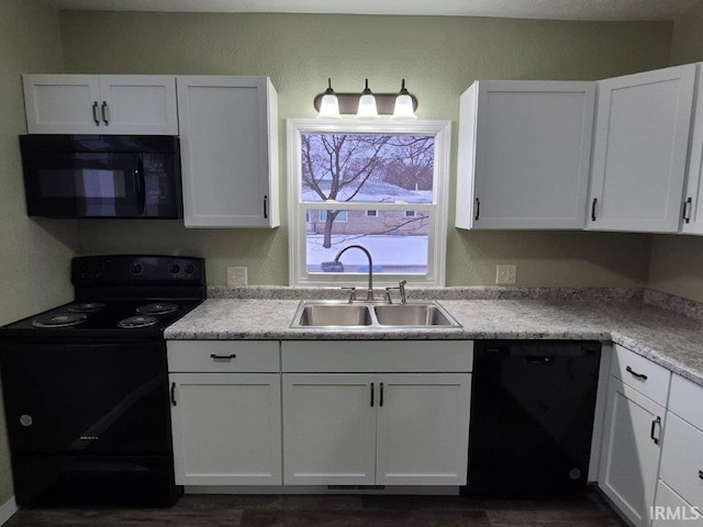 kitchen featuring white cabinets, black appliances, and sink