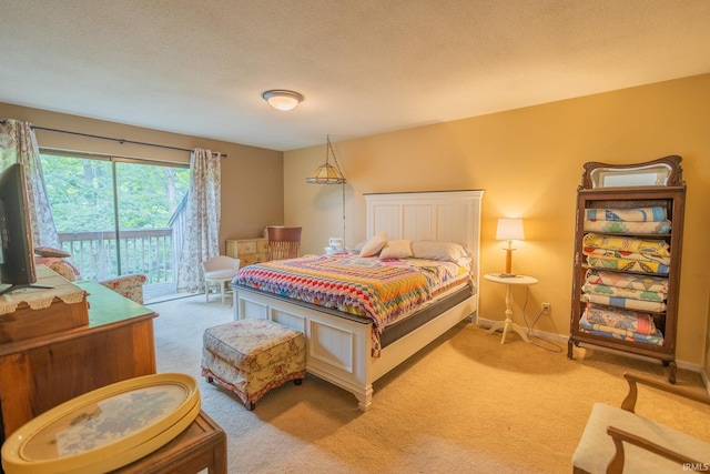 carpeted bedroom with a textured ceiling and access to exterior