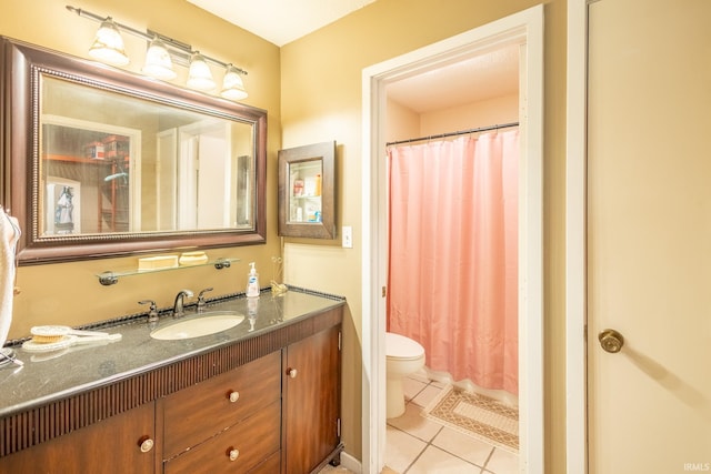 bathroom featuring tile patterned flooring, vanity, and toilet