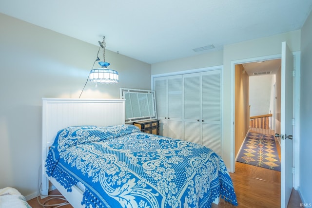 bedroom with a closet and hardwood / wood-style flooring