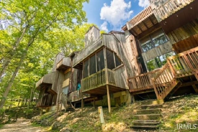 back of house featuring a sunroom