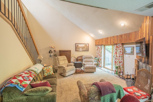 carpeted living room with a textured ceiling and lofted ceiling