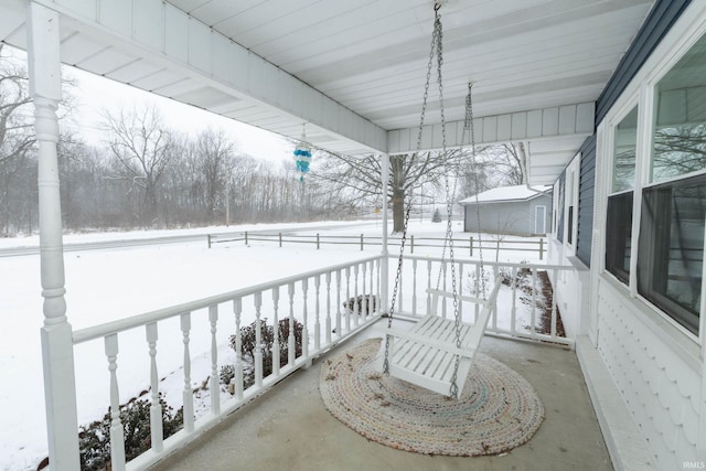 view of snow covered back of property