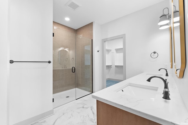 bathroom featuring walk in shower and vanity