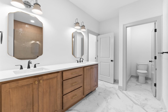 bathroom featuring toilet, vanity, and walk in shower