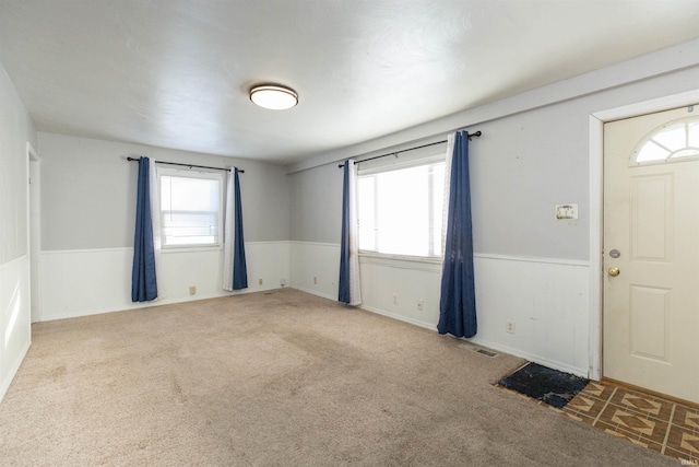 entryway with a healthy amount of sunlight and light colored carpet