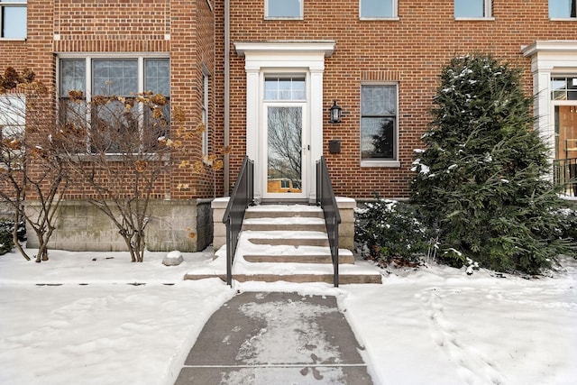 view of snow covered property entrance