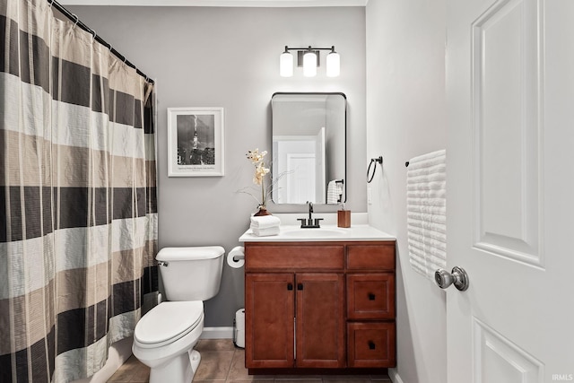 bathroom with walk in shower, vanity, tile patterned floors, and toilet