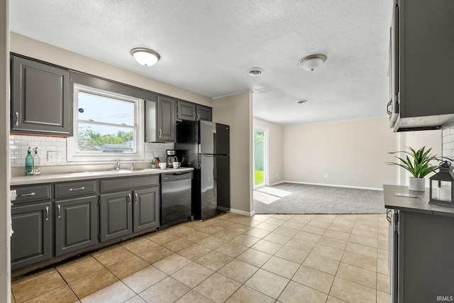 kitchen featuring light tile patterned floors, tasteful backsplash, black appliances, and gray cabinetry