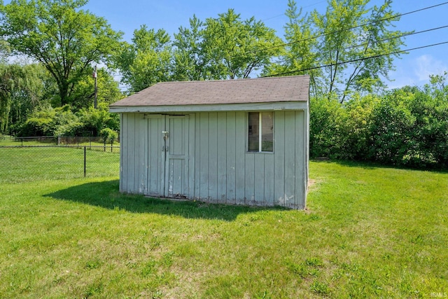 view of outbuilding featuring a lawn