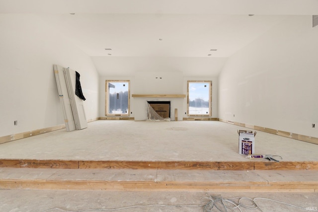 unfurnished living room featuring vaulted ceiling