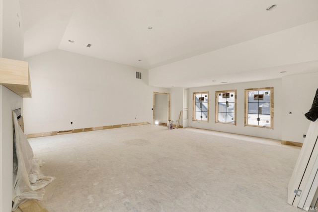 unfurnished living room featuring lofted ceiling