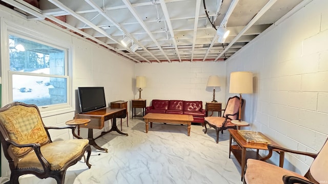 sitting room featuring concrete flooring