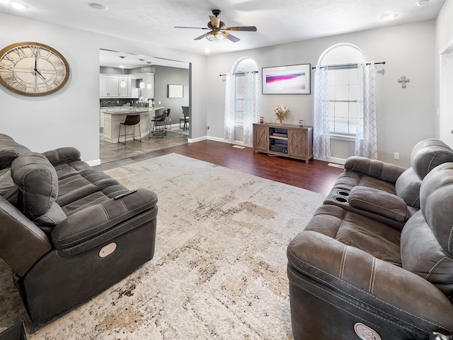 living area with ceiling fan, dark wood-style flooring, recessed lighting, and baseboards