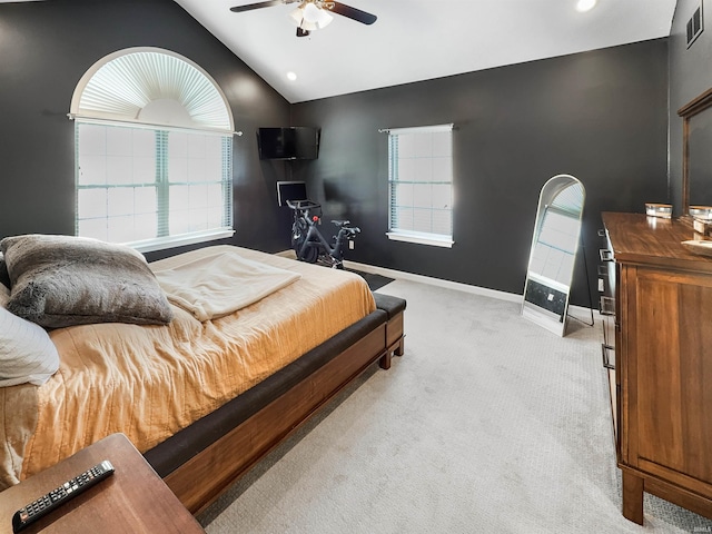 bedroom with light carpet, vaulted ceiling, baseboards, and multiple windows