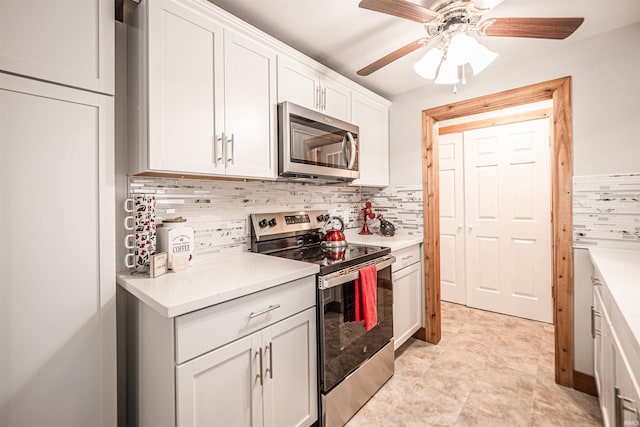 kitchen featuring stainless steel appliances, ceiling fan, white cabinets, and decorative backsplash