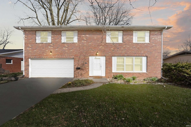 view of front of property featuring a yard and a garage