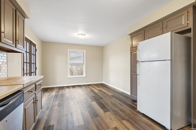 kitchen featuring white fridge, stainless steel dishwasher, and dark hardwood / wood-style floors