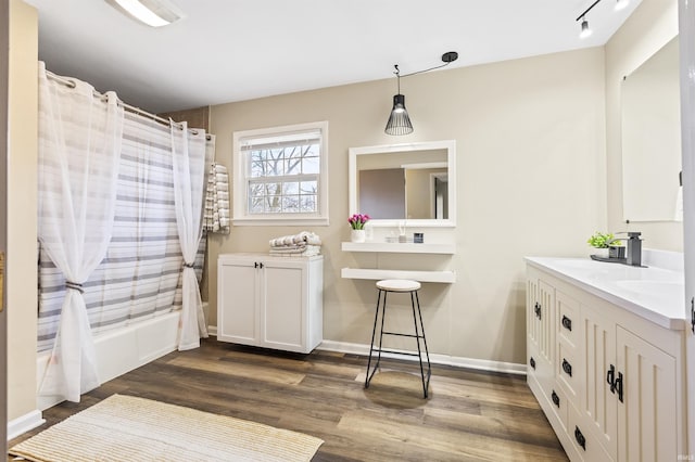 bathroom featuring shower / bath combination with curtain, vanity, and wood-type flooring