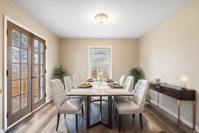 dining room with hardwood / wood-style flooring and french doors