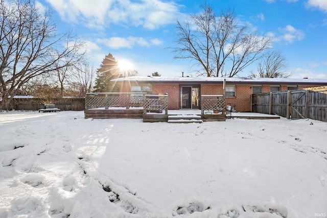 view of snow covered back of property