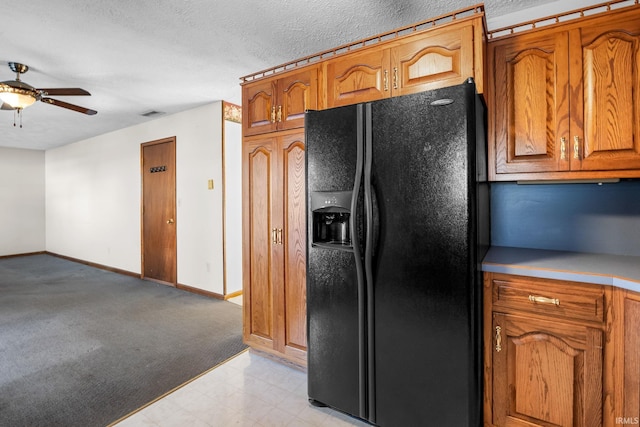 kitchen featuring black refrigerator with ice dispenser, a textured ceiling, and ceiling fan