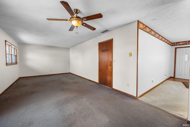 carpeted empty room featuring a textured ceiling and ceiling fan