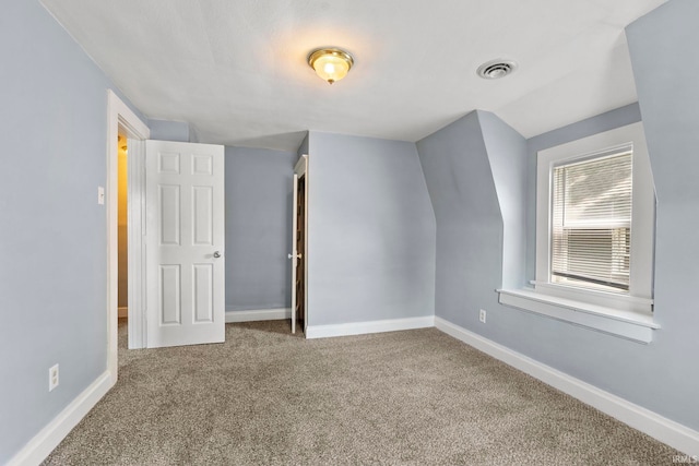 interior space with lofted ceiling and carpet