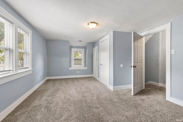 unfurnished bedroom with light carpet