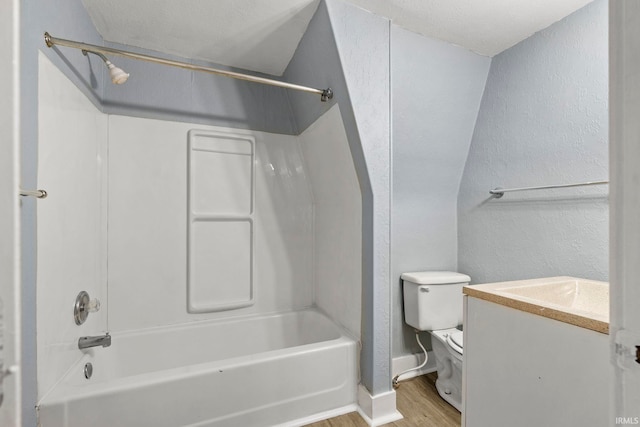 full bathroom with washtub / shower combination, hardwood / wood-style floors, vanity, and toilet