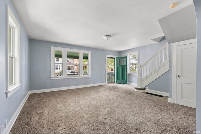 unfurnished living room with carpet