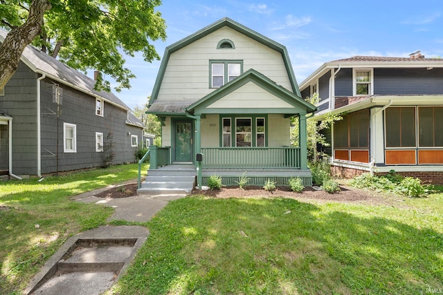 view of front of home with a front yard, covered porch, and a sunroom