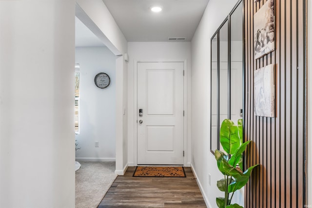 entryway featuring dark colored carpet