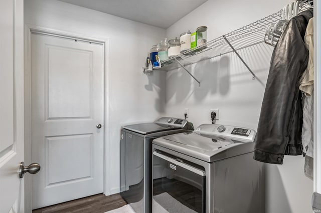 laundry area featuring dark hardwood / wood-style flooring and washing machine and dryer